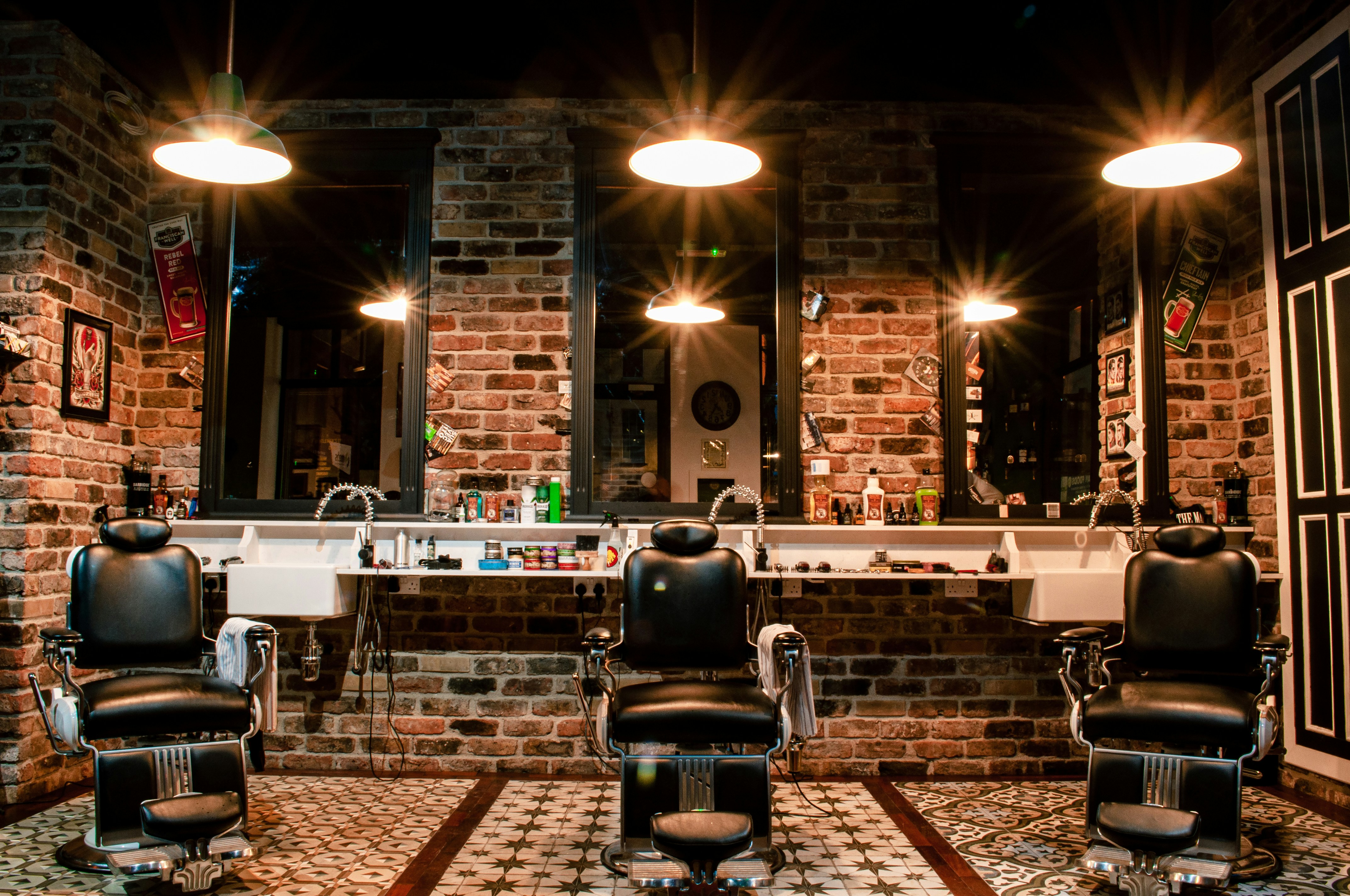 A row of empty barber chairs in a quiet shop